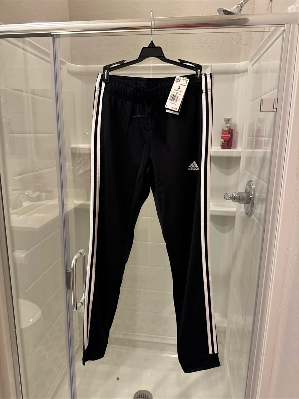 Adidas womenโs Black Track Pants with White Stripes